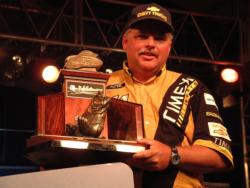 Tommy Biffle of Wagoner, Okla., shows off his first place trophy for winning the FLW tour event on the Pascagoula River in 2001. Biffle won $100,000 for his efforts.