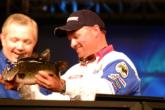 Pro Chris McCall of Jasper, Texas, shows FLW host Charlie Evans the fish he caught on the last cast of the day. McCall ultimately finished the semifinals in second place after landing a total catch weighing 13 pounds, 6 ounces.