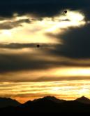 A pair of hot-air balloons takes to the early morning sky near Lake Pleasant.