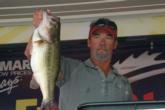 Larry Frasier shows the crowd a 6-pound bass that moved him into third place on the pro side.