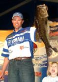 Clifford Pirch shows off his 9-2 big-bass winner as his daughter looks on.