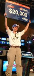 Co-angler champion Mark Myers holds up his $20,000 check.