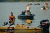 Anthony Gagliardi removes his cap for the National Anthem as a throng of spectator boats prepare to follow the pros.