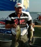 Pro Bill Walker shows off his two biggest fish from day one on the Mississippi River. Walker finished the day in fourth place.