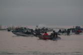 A boat stirs up the water while competitors eagerly await their number to be called.