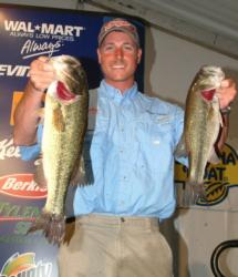 Bryan Thrift holds up a pair of bass that helped land him in fourth place after day two with a combined weight of 26-1.
