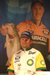 Pro Ray Scheide awaits his turn at the weigh-in stage as a larger-than-life image of eventual Wal-Mart Open winner, Andy Morgan, dominates the background.