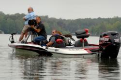 TV crews film Wendland and Busch out on the water.