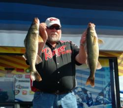 Pro winner Pete Harsh holds up two Devils Lake walleyes that propelled him to his first FLW Walleye Tour victory.