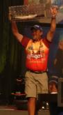 Local pro Scott Suggs triumphantly hoists his fish in the air en route to ending the day in second.