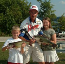 Second-place pro Roger Fitzpatrick shows off his catch with the help of his kids.
