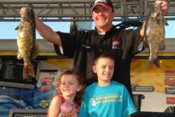 Pro Leon Knight of Tehachapi, Calif., proudly displays his 24-pound, 5-ounce catch. Knight, who finished day two in seventh place, shared the stage with his children, 8-year-old Nathanael and Kalah, 6.