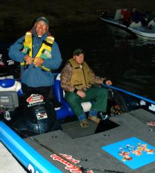 Pro Jim Tutt straps on his life jacket shortly before day-one takeoff at Sam Rayburn Reservoir, while co-angler Jason Gates awaits the action.