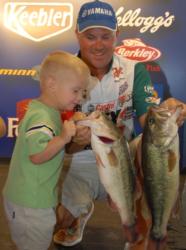 What's in there daddy? David Dudley displays his leading catch on day two while his son inspects his fish.