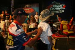 Scott Martin, currently in third place, autographs a young fan