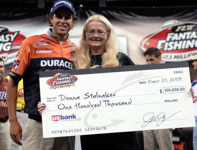 2008 Forrest Wood Cup winning pro Michael Bennett presents a $100,000 check to the FLW Fantasy Fishing winner for the Cup: Donna Stalnaker.