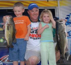 Castrol pro David Dudley shows off his biggest bass with a little help from two of his children.