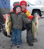 Aaron McManaway of Altamont, Ill., gets a little help from his son showing off his 20-13 catch on day one for fourth place.