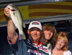 Joined by his son Sonny and girlfriend Chariti Wilkins, Roy Hawk shows off one of his winning bass.