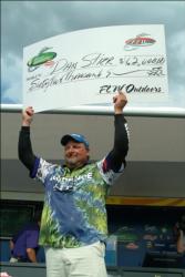 Dan Stier of Pierre, S.D., hoisted a check for $62,000 over his head after winning the Walmart FLW Walleye Tour event on Leech Lake with 56 pounds, 5 ounces.