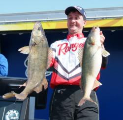 Pro Tom Keenan holds up two nice Lake Erie walleyes.