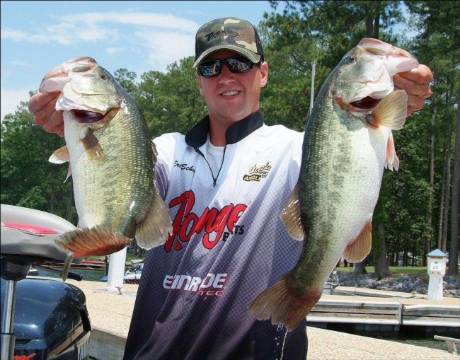 Second-place co-angler Eric Schultz holds up two Guntersville hogs.