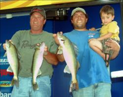 Pro Paul Steffen of Pierre, S.D., holding 3-year-old Kelby Olson, is in second place on Oahe. He fished Friday with co-angler William Drake, also pictured.