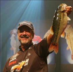 Third-place pro Larry Nixon holds up his biggest bass from day four on Lake Lanier.