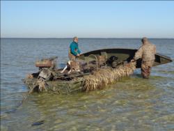 Approaching hunting spots in shallow draft duck boats, hunters may opt to paddle the rest of the way in a pirogue.