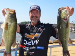 Larry Nixon proudly displays his 20-pound, 2-ounce stringer. Nixon's catch placed him in a tie for first place with  Vic Vatalaro during the opening round of FLW Tour competition on the Potomac River.
