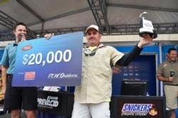 Cory Leonard of Castalia, N.C., proudly displays his first-place check and trophy after winning the FLW Tour co-angler tournament title on the Potomac River.