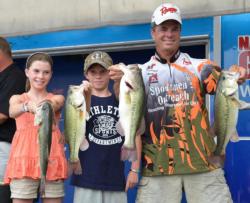 With some help from his daughter Rachel and his son Caleb, second-place pro Glenn Chappelear holds up his day-two catch. 