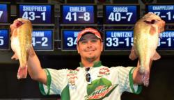Fifth-place pro Jason Christie holds up his two biggest bass from day three on Kentucky Lake.