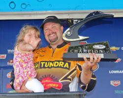 Pro winner Michael C. Tuck celebrates his victory with his 3-year-old daughter Reagan.
