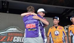 As the second place UW Stevens Point team looks on, Northwestern University teammates Jimmy Morrow and Matthew Kestufskie share an embrace winning the FLW College Fishing Central Regional Championship.
