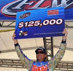 National Guard pro Scott Martin of Clewiston, Fla., proudly displays his first-place check after capturing the FLW Tour title on the Potomac River.