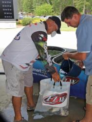 Tim Reneau gets a bucket of fresh water on his fish after taking the day-one lead.