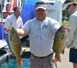 Co-angler leader Dave Hasty holds up a pair of nice smallmouths from day two. 