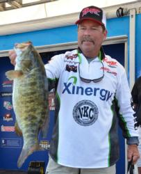 Co-angler Tom Spangler holds up a 6-pound, 7-ounce smallmouth - the Snickers Big Bass from day two. 