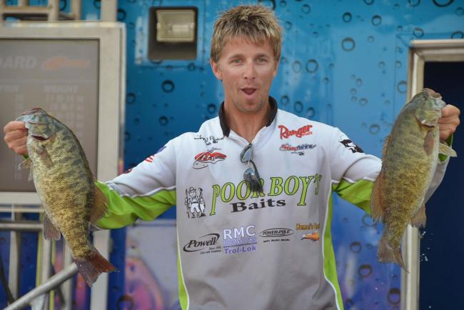 Third-place pro Chad Pipkens holds up his two biggest bass from day four on Lake Erie.