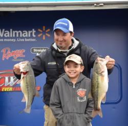 Shawn Kowal and his son pose with two bass from his 20 pound final-day limit. 