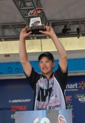 Co-angler champion Bryan New holds up his trophy.