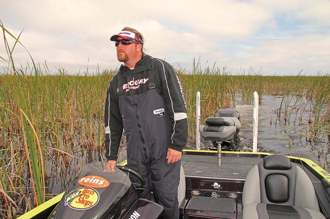 FLW Tour pro JT Kenney carefully surveys the landscape while searching for prime fishing locations off the beaten path.