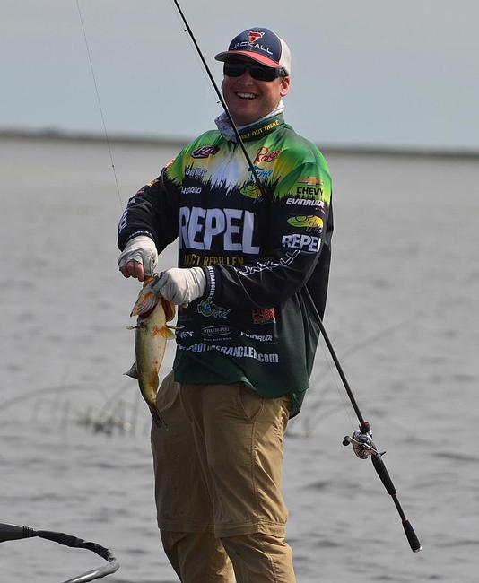 Cody Meyer laughs as he tosses back a 3-pound bass that won