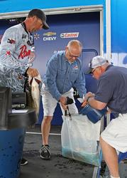 Day-two leader Russell Cecil loads his fish back into his bag after taking over the pro division.