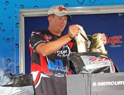 Bryan Schmitt loads his two biggest bass into the weigh-in basket.