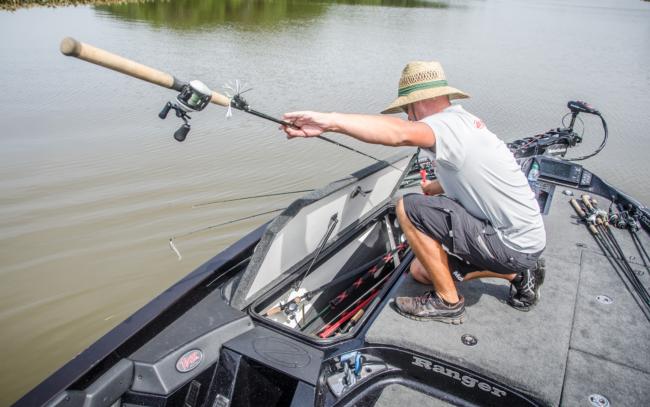 Davis goes into the rod locker to look for something else to help cover water more effectively. He settles on a frog which is one of his favorite ways to catch bass.