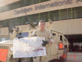 Ken Chapman, U.S. Army, holds a banner signed by Wal-Mart FLW Tour pros that was sent to his unit in Iraq.