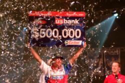 2004 FLW Tour champion Luke Clausen smiles as he hoists his hefty check in a sea of celebratory confetti.