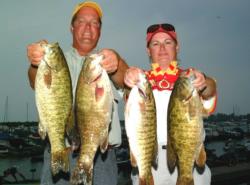 After catching 19 pounds Wednesday, Brian Hensley of Edwardsburg, Mich., caught another limit that weighed 21-6 Thursday - the heaviest sack of the opening round - and led with a two-day total of 40-6. Helping him hold his fish is his wife, 2001 EverStart Series Championship co-angler winner Renee Hensley.